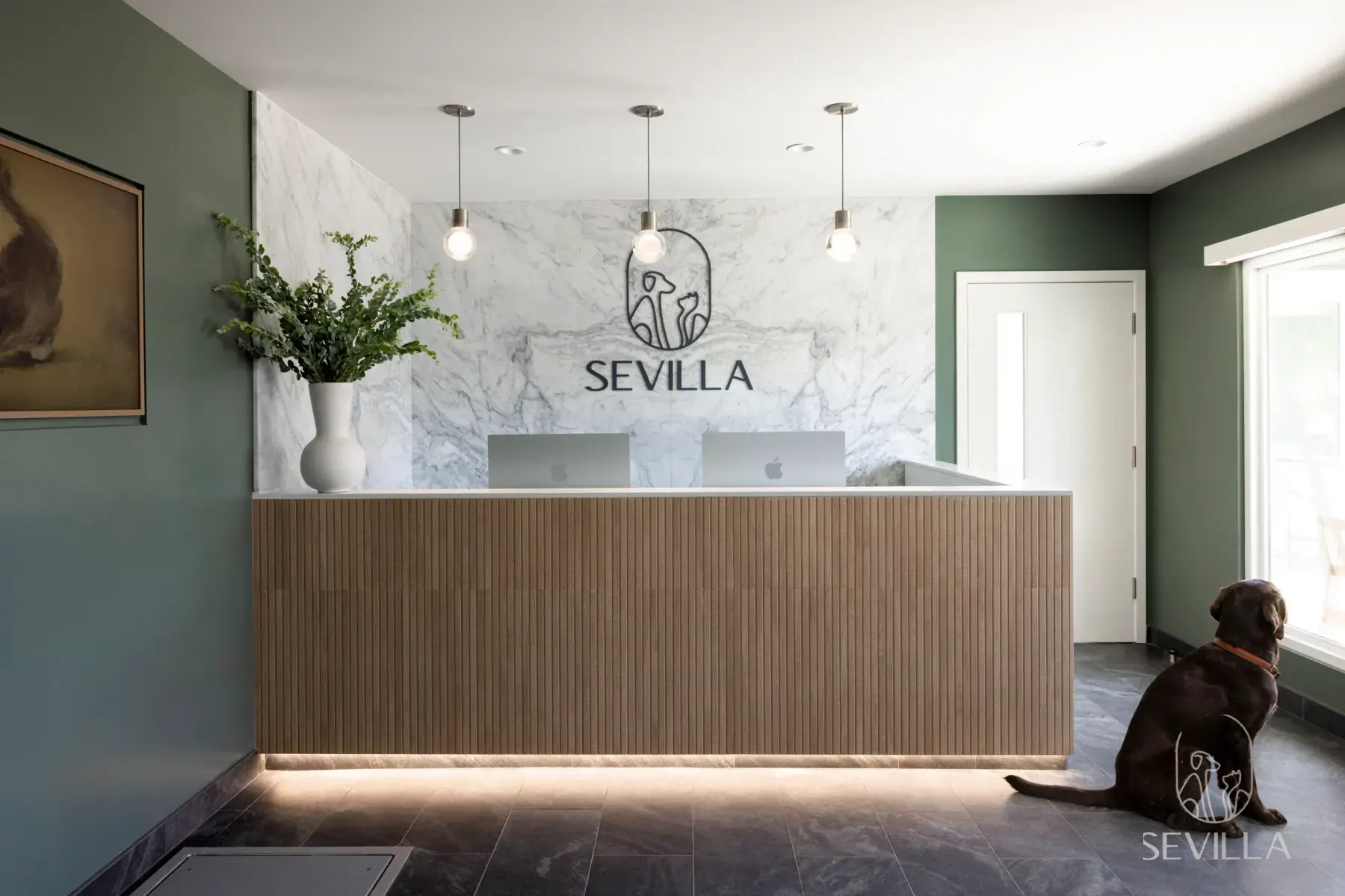 Reception desk with Sevilla branding inside a veterinary clinic